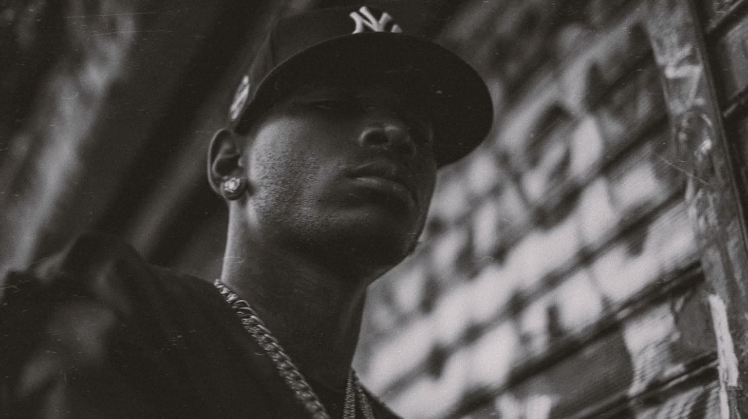 Collector in a New York cap against a graffiti wall